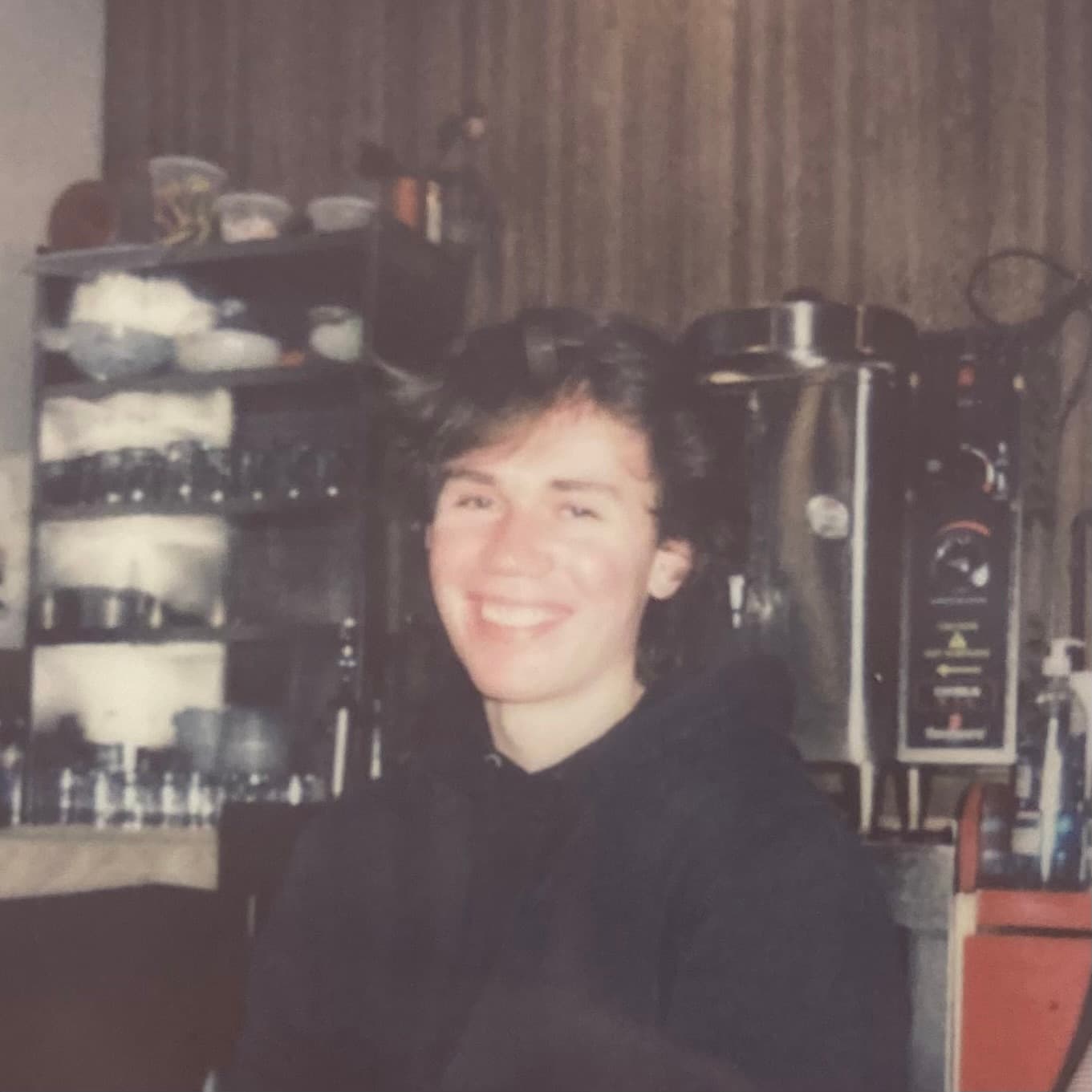 A washed out polaroid picture of me smiling.